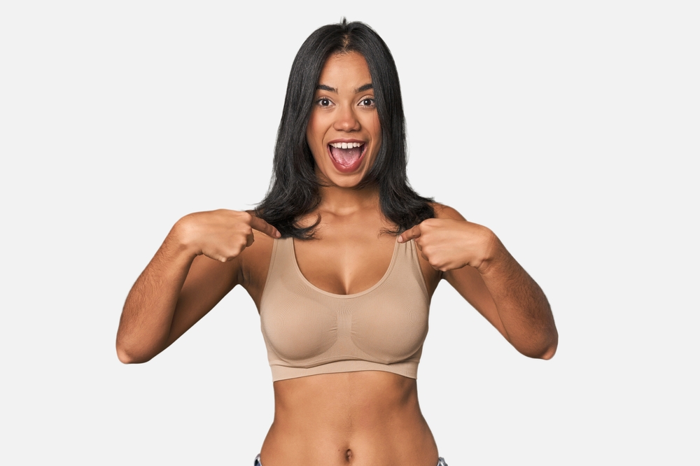 Young,Filipino,Woman,In,Light,Wear,Surprised,Pointing,With,Finger,